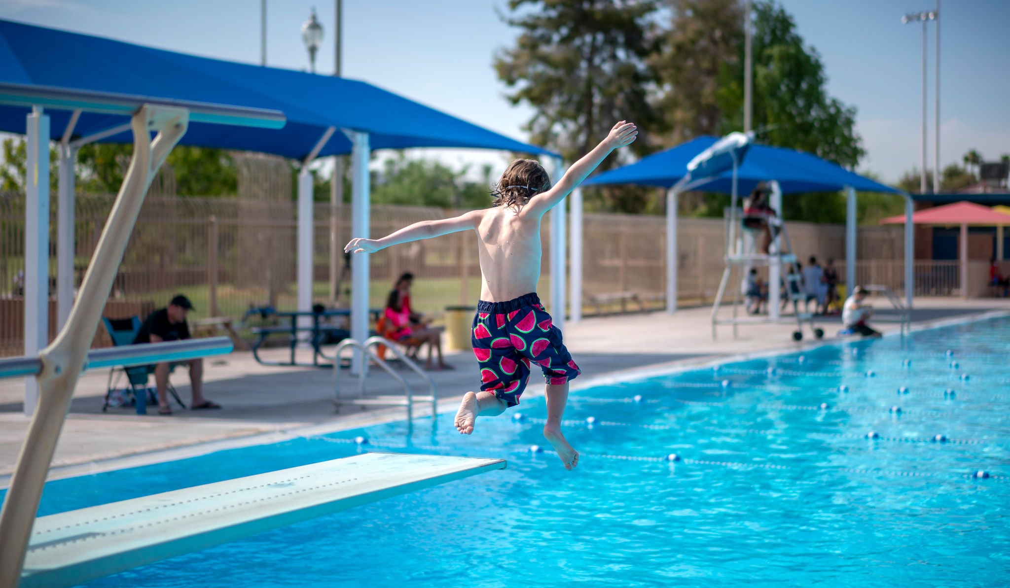 Child jumping into Encanto Pool. 